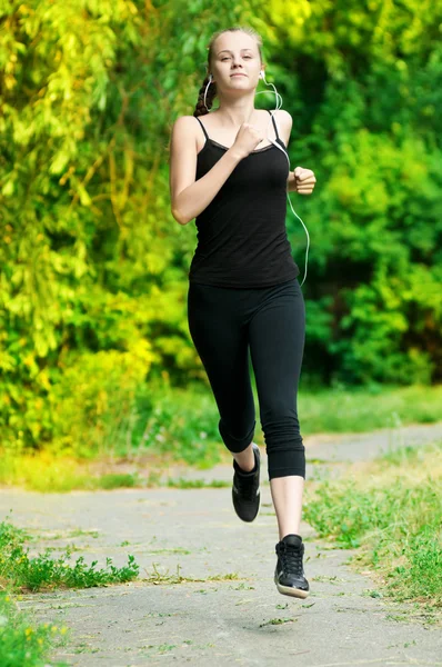 Jovem mulher correndo no parque verde — Fotografia de Stock