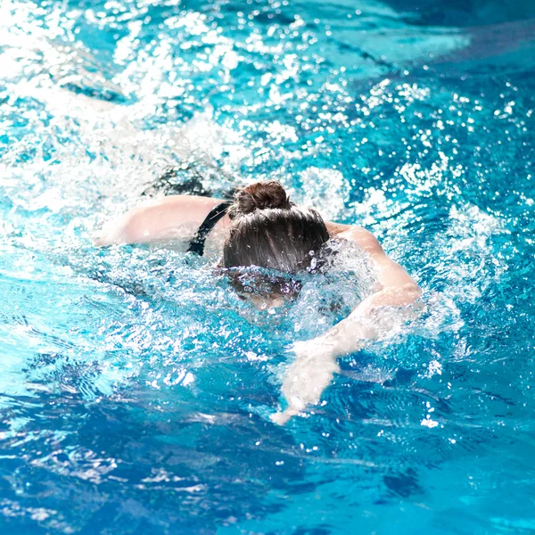 Simmare kvinna utför crawlningen stroke — Stockfoto