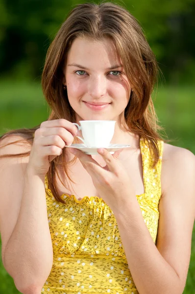 Όμορφη νεαρή γυναίκα ποτό ζεστό καφέ εξωτερική — Φωτογραφία Αρχείου