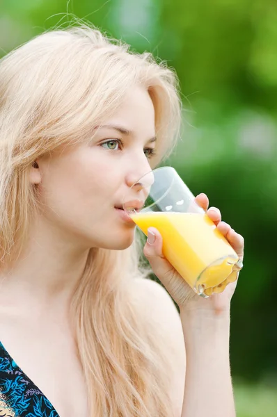 stock image Smiling woman drinking orange juice