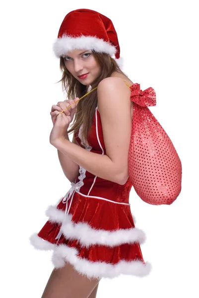 Женщина в платье из Санта-Клауса и сумка с подарками — стоковое фото