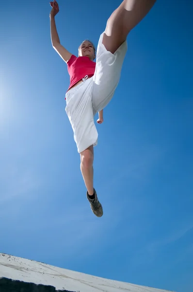 Beautiful woman jump into sky — Stock Photo, Image