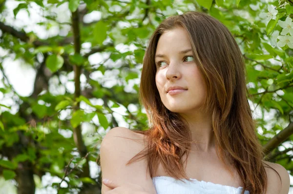 Beautiful young woman relaxing in apple tree garden — Stock Photo, Image