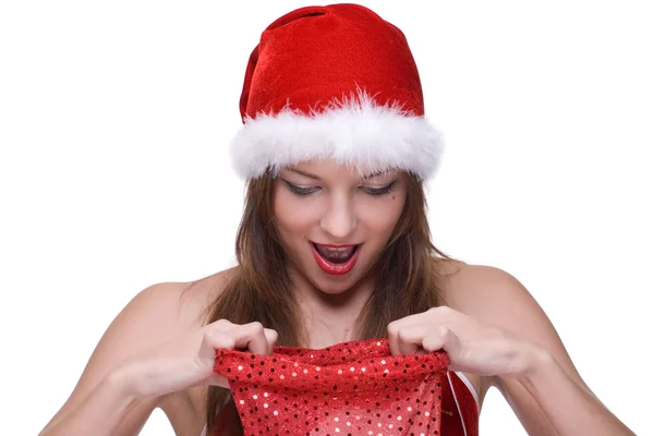 Closeup of girl in santa clause dress and gifts bag — Stock Photo, Image
