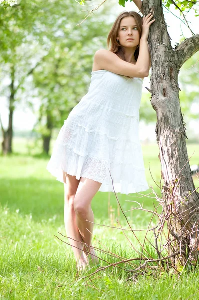 stock image Beautiful young woman relaxing in apple tree garden