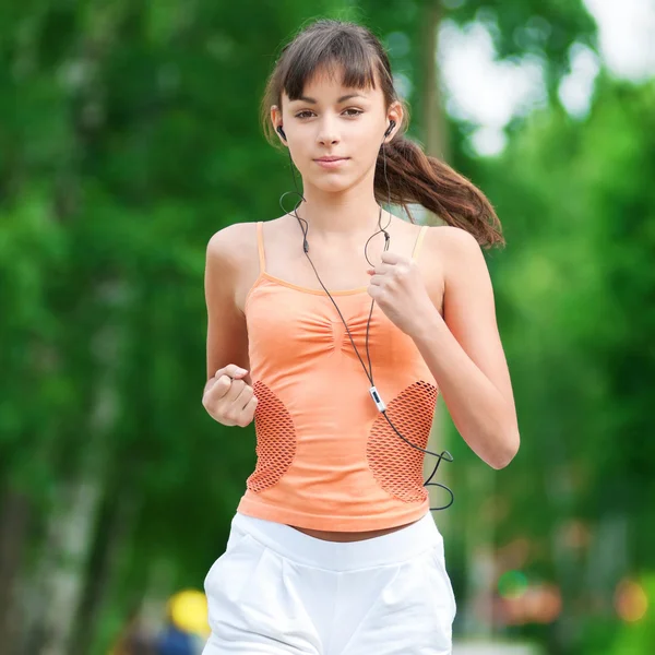 Teenage girl running in green park Royalty Free Stock Photos
