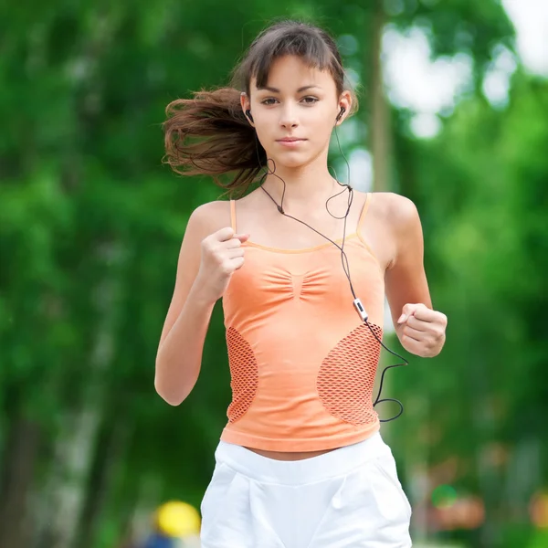 Teenage girl running in green park Stock Image