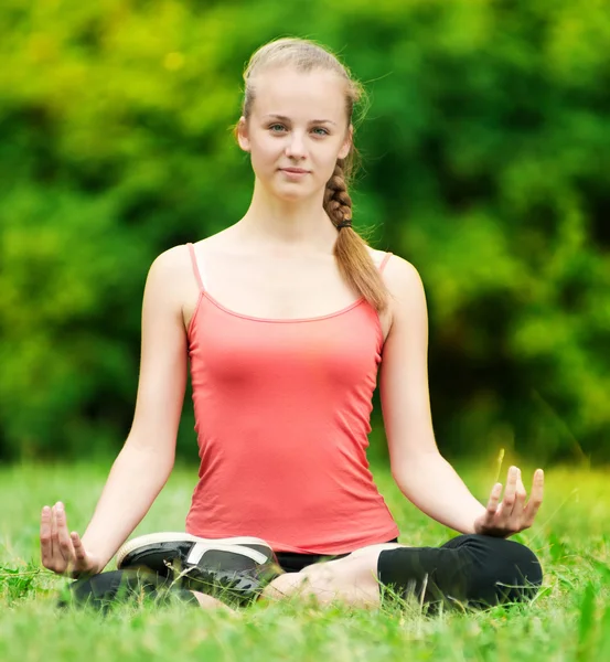 Young woman doing stretching exercise Stock Photo