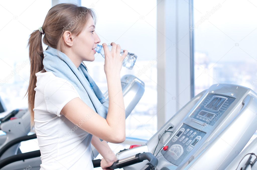 Woman at the gym drinking water