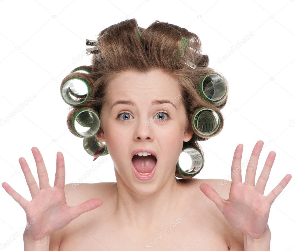 Woman curling her hair with roller