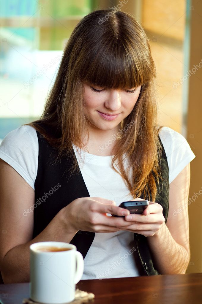 Woman sitting in a cafe with a coffe