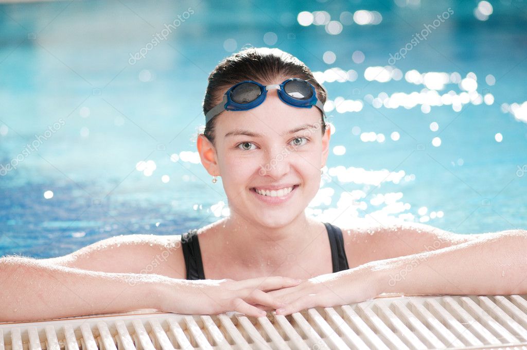 Woman in black goggles in swimming pool