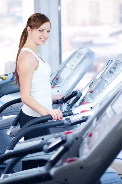 Young woman at the run at gym — Stock Photo, Image