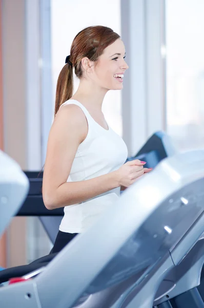 Young woman at the run at gym — Stock Photo, Image