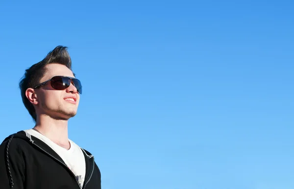 Close up of teenager over blue sky — Stock Photo, Image