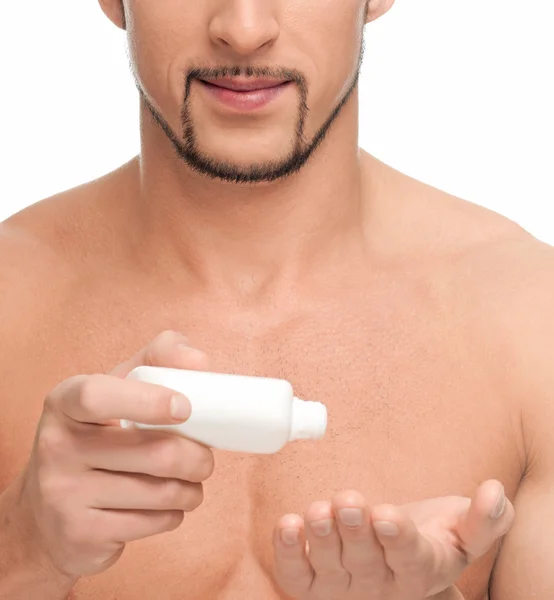 Young man applying cream. Cosmetic — Stock Photo, Image