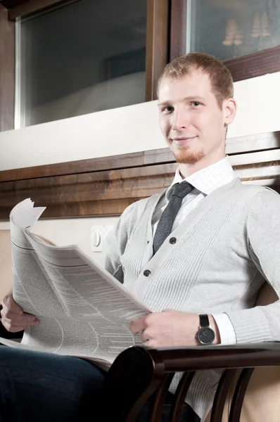 Sure young business man with newspaper — Stock Photo, Image