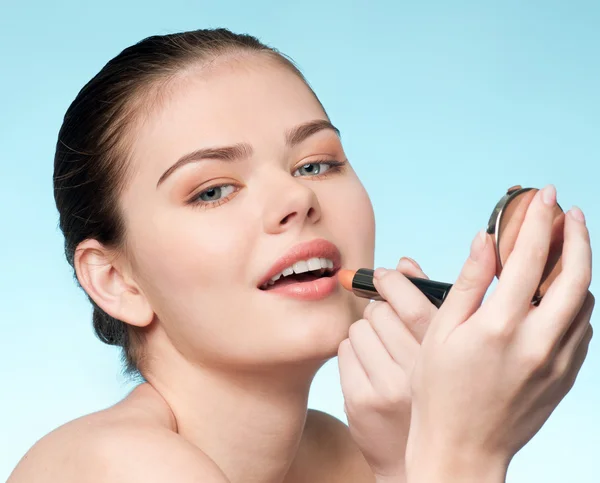 Beautiful young adult woman applying cosmetic lipstick — Stock Photo, Image
