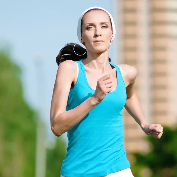 stock image Beautiful woman running in green park