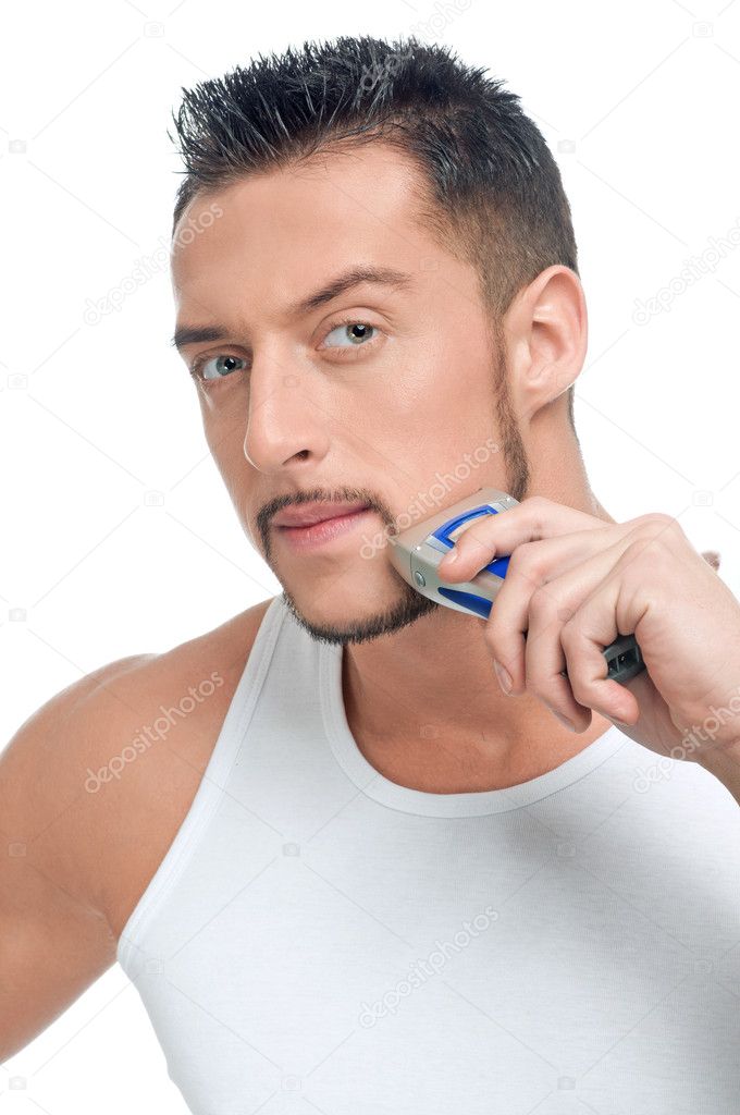 Young handsome man shaving