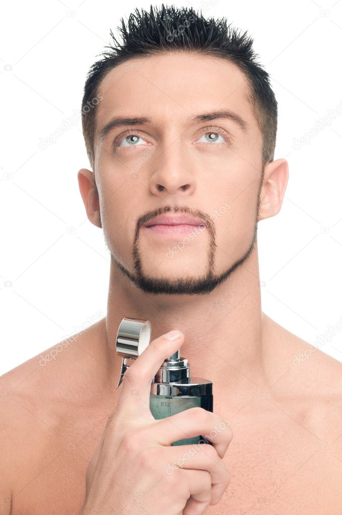 Young handsome man applying perfume