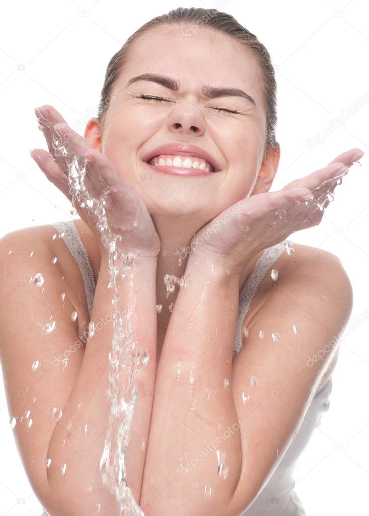 Close-up of beautiful woman washing her face