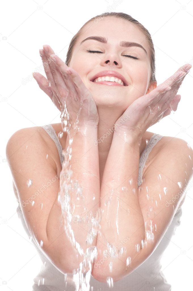 Close-up of beautiful woman washing her face