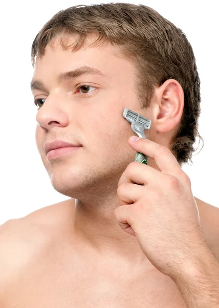 Portrait of a young handsome man shaving — Stock Photo, Image
