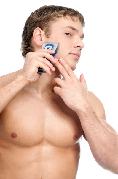 Portrait of a young handsome man shaving — Stock Photo, Image