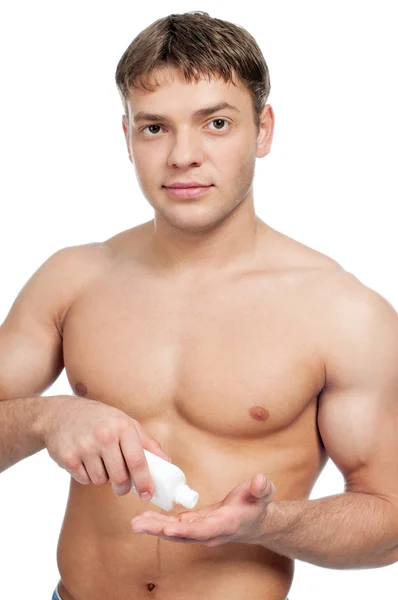 Man putting on cream lotion — Stock Photo, Image