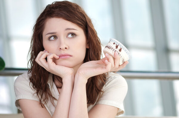 Young happy woman with cake