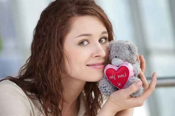 Beautiful young woman with a toy — Stock Photo, Image