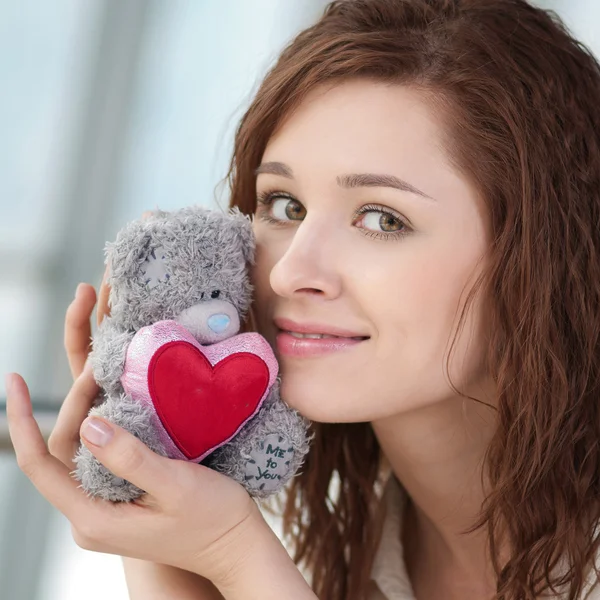 Beautiful young woman with a toy — Stock Photo, Image