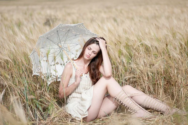 Eenzame vrouw zitten in tarweveld — Stockfoto