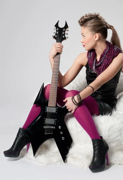 Beautiful young rock girl with black guitar — Stock Photo, Image