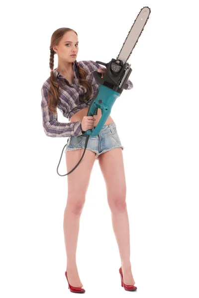 Young worker woman in jeans coverall with chain saw — Stock Photo, Image