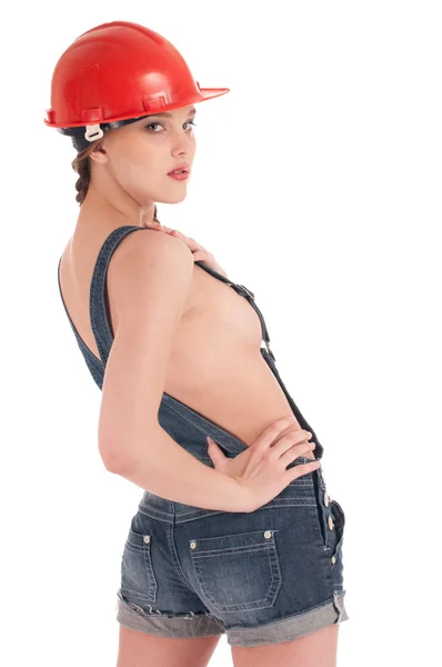 Jonge werknemers vrouw in jeans coverall en oranje helm — Stockfoto