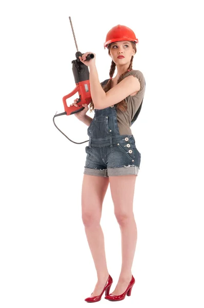 Молода грайлива жінка в джинсах обкладинка тримає дриль перфоратора — стокове фото