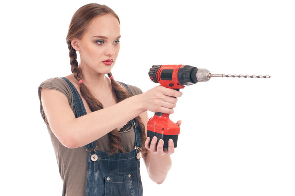 Young woman holding drill with auger