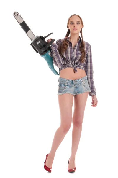 Young worker woman in jeans coverall with chain saw — Stock Photo, Image