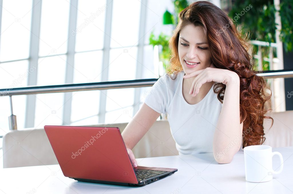 A young business woman sitting in a cafe