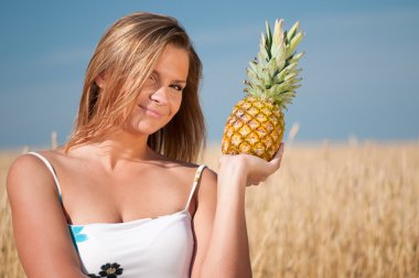 Woman eating pineapple. Summer picnic. clipart