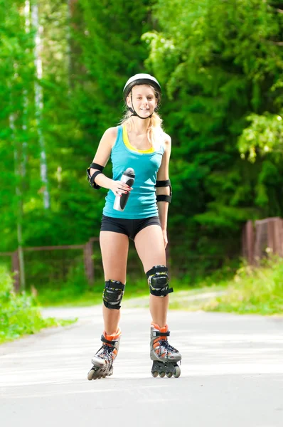 Young brunette woman on roller skates — Stock Photo, Image