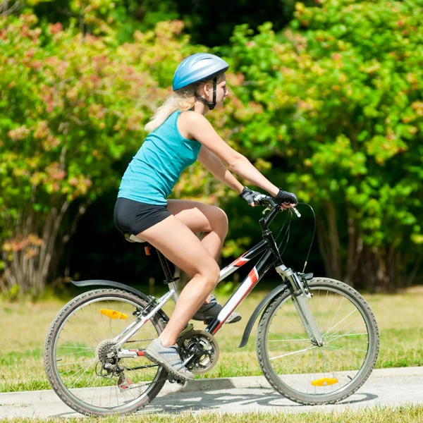 Young smiling woman on bike Royalty Free Stock Images