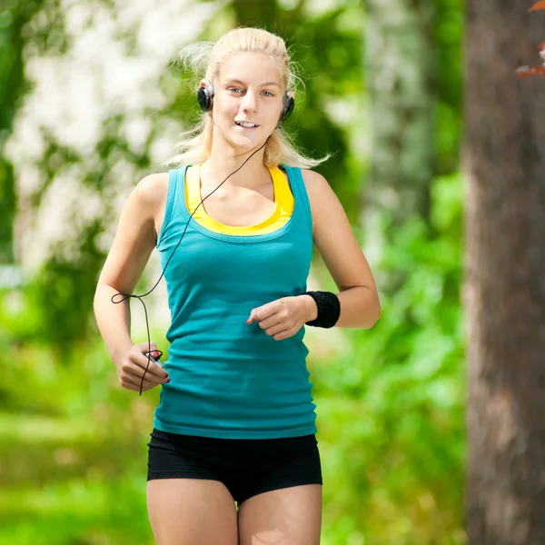 Beautiful young woman running on music Stock Picture