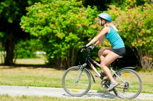 Young smiling woman on bike Stock Photo