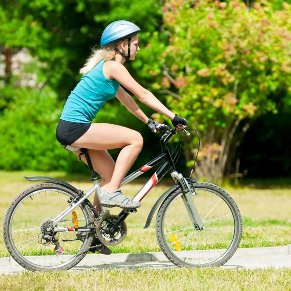 Young smiling woman on bike Royalty Free Stock Images