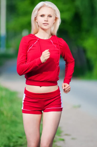 Beautiful woman running in park — Stock Photo, Image