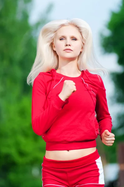 Beautiful woman running in park — Stock Photo, Image