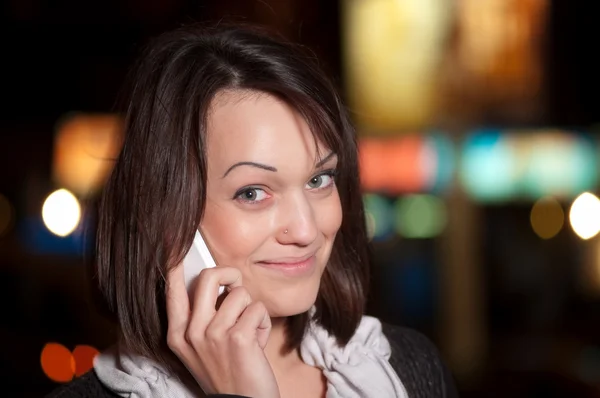 Woman with mobile cell phone over night city — Stock Photo, Image